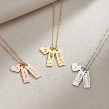 Close-up of gold, rose gold, and silver heart necklaces engraved with the names Sophia, Ethan, and Liam and personalized dates