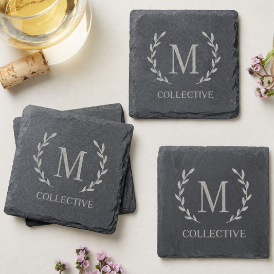 Personalized monogram slate coaster set engraved with "M" and "COLLECTIVE" on a light background